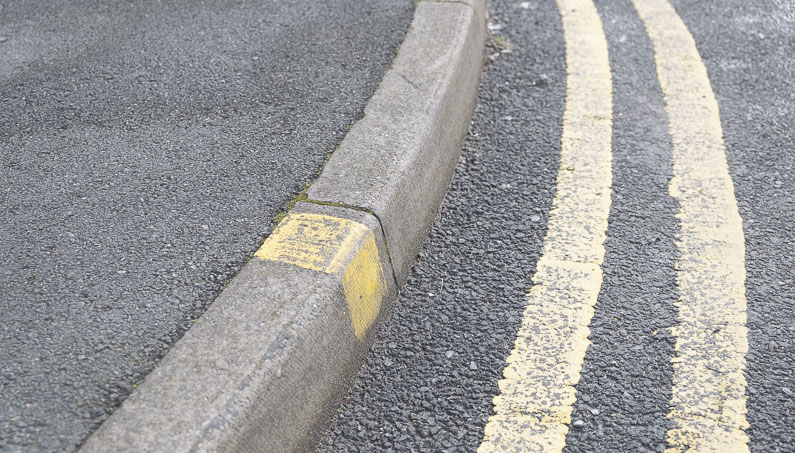 Yellow lines on the road and pavement to show no waiting and loading