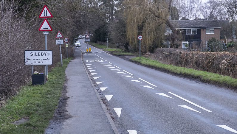 Signs and road markings at the entrance of a town, village or built-up area